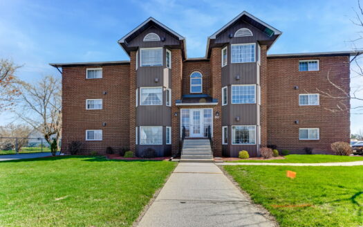 Bright living room with bay window in 2-bedroom Arnprior condo for sale