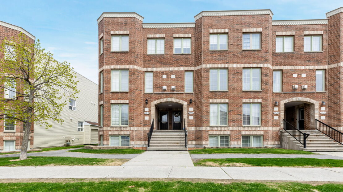Bright Barrhaven condo living room with fireplace and patio access